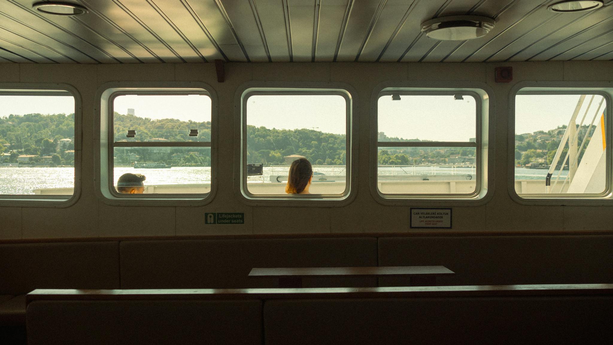 Experience serene travel moments on a ferry, showcasing scenic vistas through cabin windows.